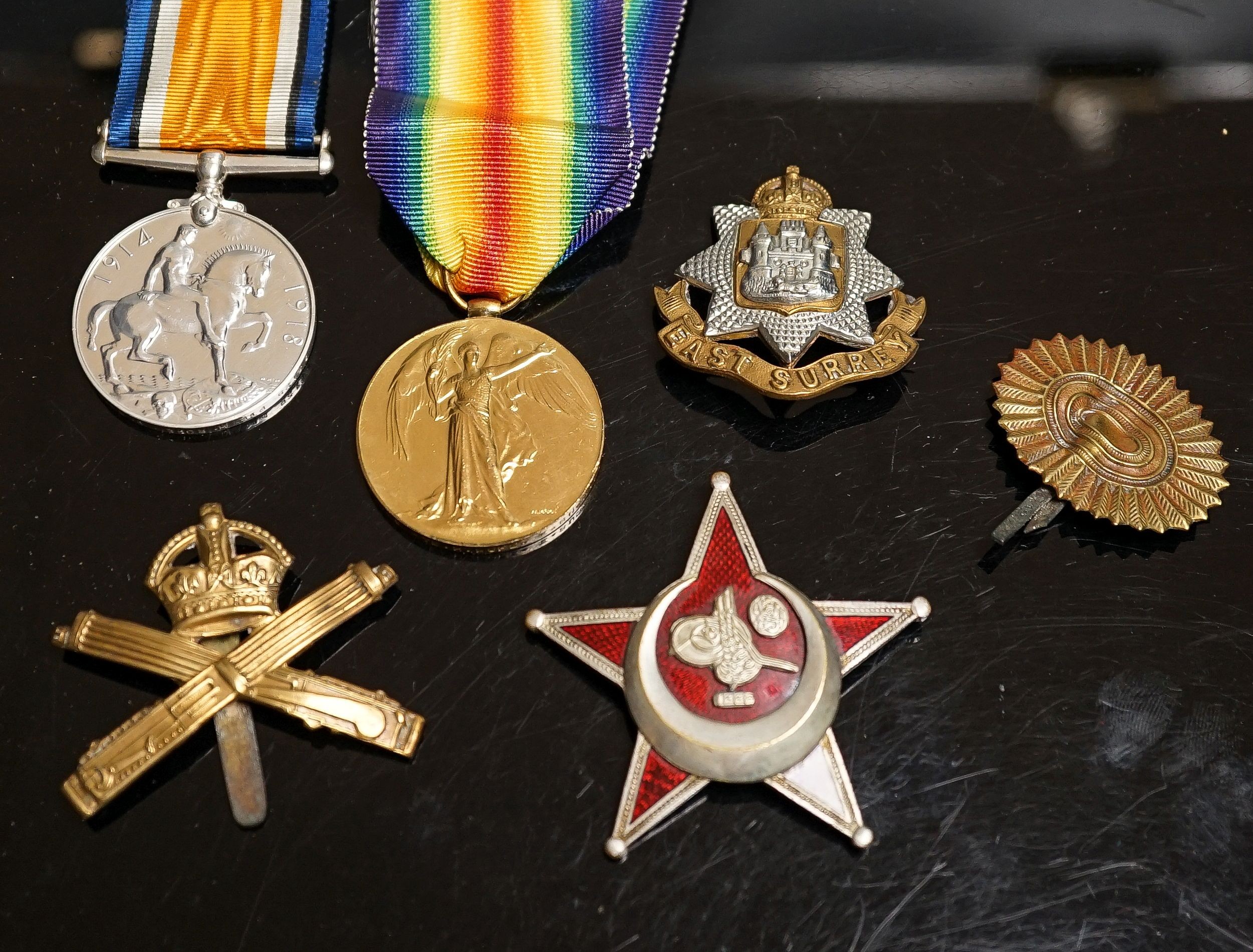 A WWI pair to 23125 PTE. H. ROFE E.SUR. R., together with an East Surrey Regiment cap badge, two other cap badges and a Gallipoli star